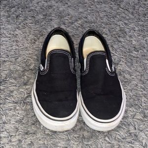 All black slip on vans